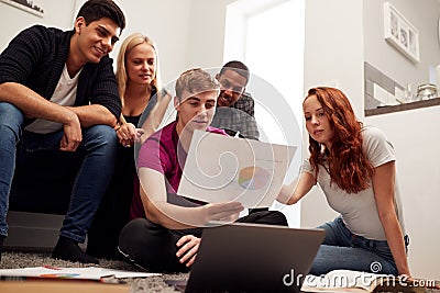 Group Of College Students In Lounge Of Shared House Studying Together Stock Photo