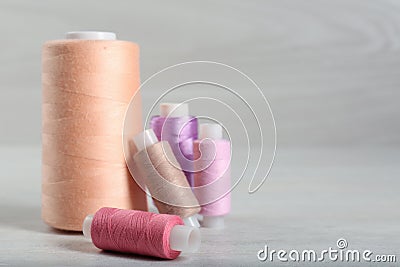 Group of color threads coils on white wooden table. Space for text Stock Photo