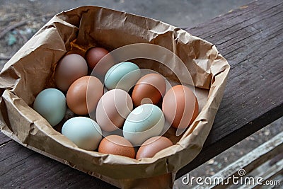 Group of Colorful Farm Fresh Eggs in a Brown Paper Bag Stock Photo