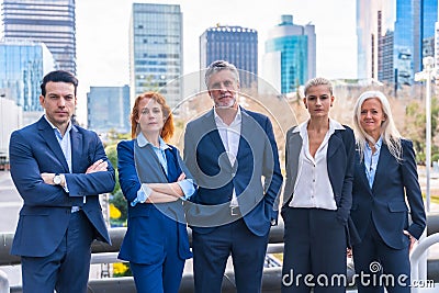 Group of confident business professionals posing in front of a modern building Stock Photo