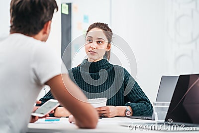 Group of coworkers looking at computer monitor while working in office Stock Photo