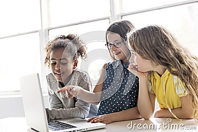 Group of curious children watching stuff on the laptop screen Stock Photo