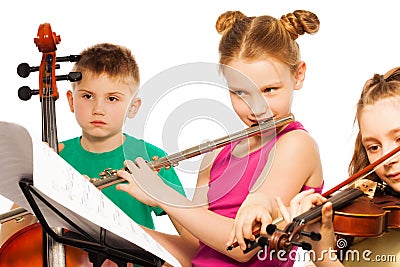 Group of cute kids playing on musical instruments Stock Photo