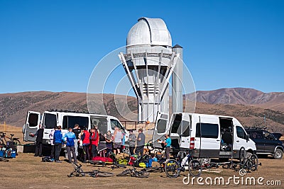 Group cyclists with support vehicles on Assy plateau. Bicycle tour journey concept. Healthy lifestyle, sport. Travel, tourism in Editorial Stock Photo