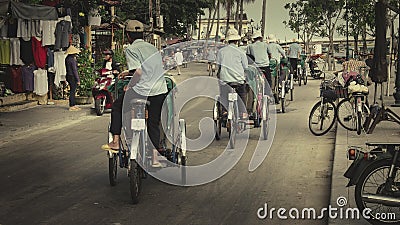 Group of cyclo drivers driving on the stress, Hoi An ancient town Vietnam Editorial Stock Photo