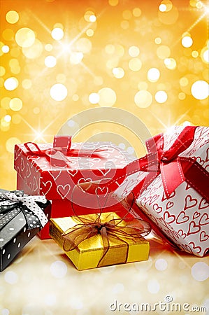 Group decorative gift boxes Golden bokeh front view vertical com Stock Photo
