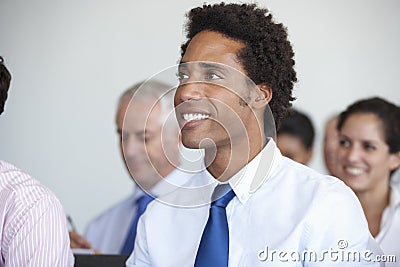 Group Of Delegates Listening To Presentation At Conference Stock Photo