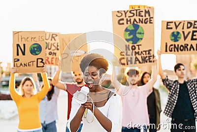 Group demonstrators protesting against plastic pollution and climate change - Multiracial people fighting on road holding banners Stock Photo