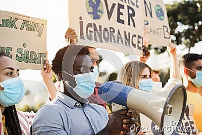 Group of demonstrators on road from different culture and race protest for climate change during coronavirus outbreak - Focus on Stock Photo