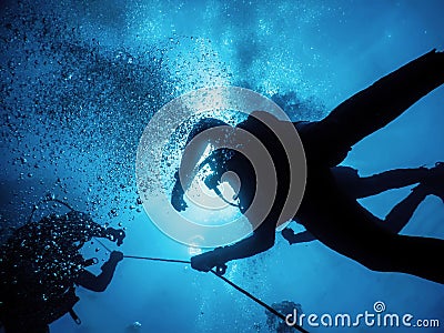 Group of Divers on Safety Stop Underwater Bubbles Stock Photo
