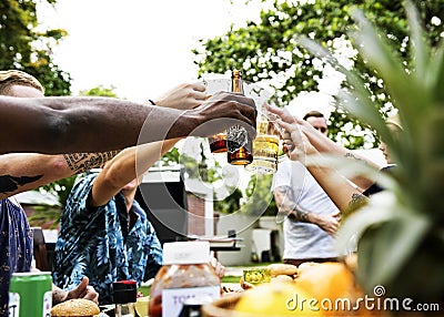 Group of diverse friends celebrating drinking beers together summer time Stock Photo