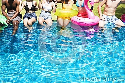 Group of diverse friends enjoying summer time by the pool with i Stock Photo
