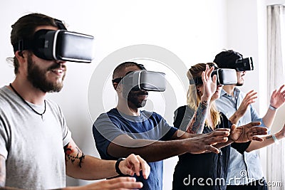 Group of diverse friends experiencing virtual reality with VR headset Stock Photo