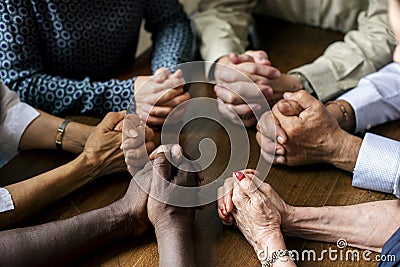 Group of diverse hands are praying together Stock Photo