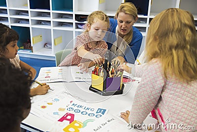 Group of diverse Kids coloring workbook in class Stock Photo