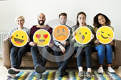 Group of diverse people holding emoticon icons Stock Photo