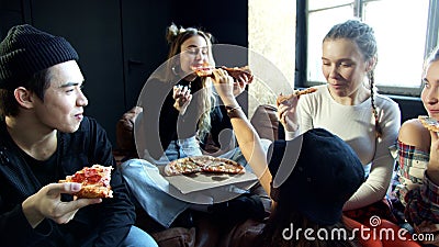 Group of diverse schoolkids eat pizza and laugh Stock Photo