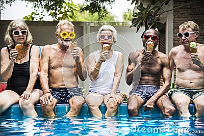 Group of diverse senior adults eating ice cream together Stock Photo