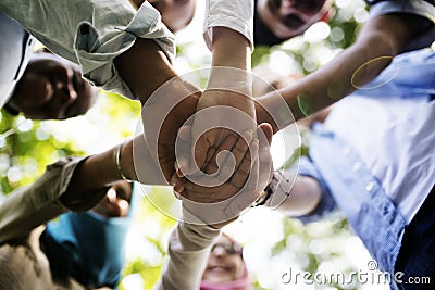Group of diverse youth with teamwork joined hands Stock Photo