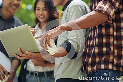 Group of Diversity Student working on laptop together at university,Happy multi ethnic friend successfully completes the thesis Stock Photo