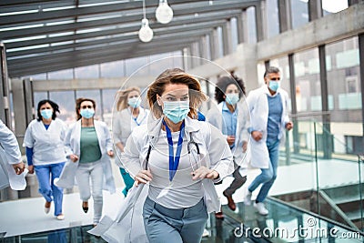 Group of doctors with face masks running, corona virus concept. Stock Photo