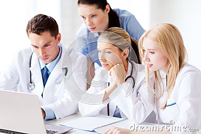 Group of doctors looking at tablet pc Stock Photo