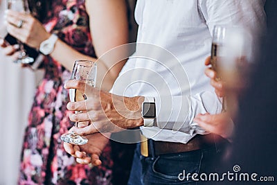 Group of elegant people holding glasses of champagne at luxury w Stock Photo