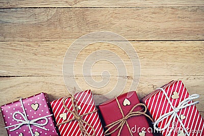 Group of elegant red gift box decoration on wood background, vibrant valentine lovely present concept Stock Photo