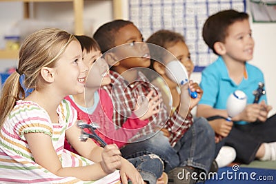 Group Of Elementary Age Schoolchildren In Music Class With Instruments Stock Photo