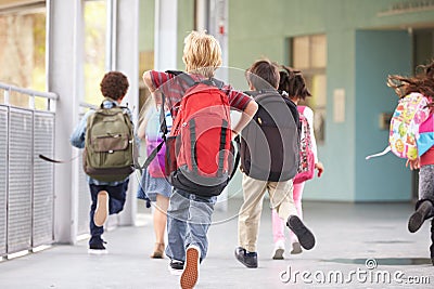 Group of elementary school kids running at school, back view Stock Photo