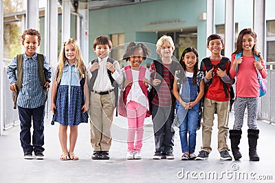 Group of elementary school kids standing in school corridor Stock Photo