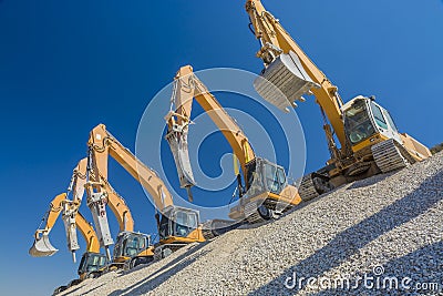 Group of excavators on gravel hill Stock Photo