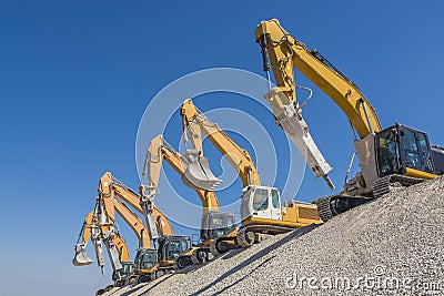 Group of excavators on gravel hill Stock Photo