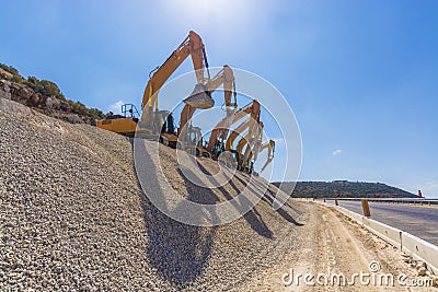 Group of excavators on gravel hill Stock Photo