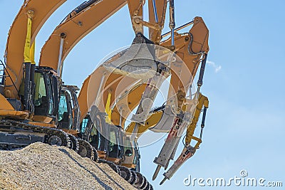 Group of excavators on gravel hill Stock Photo