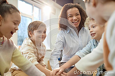 Group of Excited Children Huddling Stock Photo