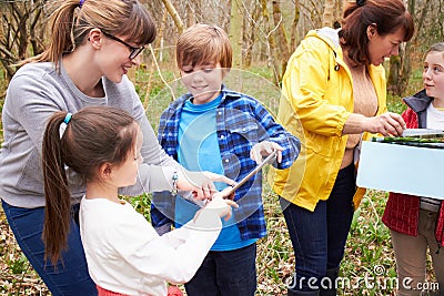 Group Exploring Woods At Outdoor Activity Centre Stock Photo