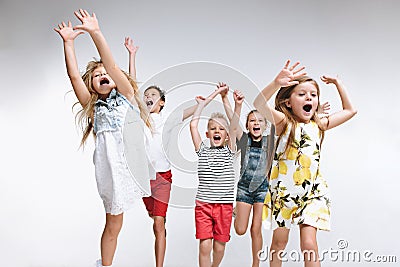 Group fashion cute preschooler kids friends posing together and looking at camera white background Stock Photo