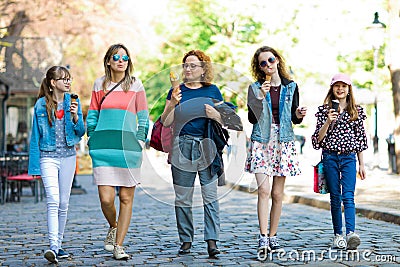 Group of fashion girls walking through downtown - having ice cre Stock Photo