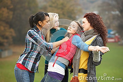 Group Of Female Teenagers Bullying Girl Stock Photo