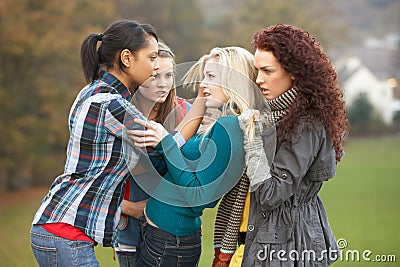 Group Of Female Teenagers Bullying Girl Stock Photo