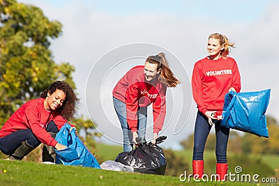 Group Of Female Volunteers Collecting Litter Stock Photo