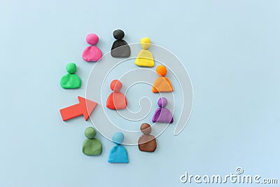 group of figures going in one direction and a unique person heading in a different direction Stock Photo