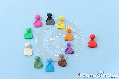 group of figures going in one direction and a unique person heading in a different direction Stock Photo