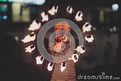 Group of fire artists fakir perform amazing show at night with flamethrowers, fire dancers, chain of fire, extreme breathing Stock Photo