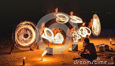 Group of firestarter performing amazing fire show with sparkles at night - Full moon party event festival in Thailand nightlife Editorial Stock Photo