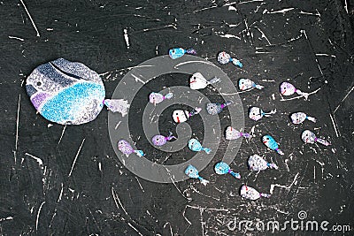 Group of fish from the fabric follows their leader on the black board. Leadership, success and teamwork concept. Leadership in a Stock Photo