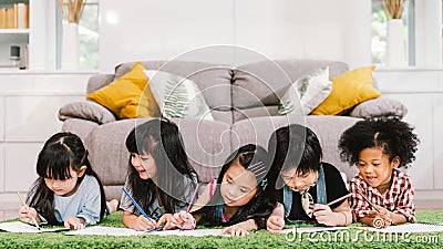 Group of five multi-ethnic young cute preschool kids, boy and girls happy studying or drawing together at home or school Stock Photo