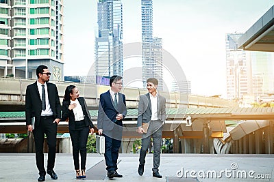 A group of four Asian businessmen Standing meeting for discussions on real estate investment in Asia. Stock Photo