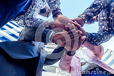 A group of four black afro american friends men businessmen in stylish business suit, expensive wristwatch handshake Stock Photo